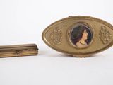 a picture of a woman in a picture on a gold broochle