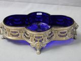 a blue glass bowl sitting on top of a white table