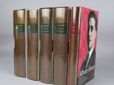 five books in a row with a picture of a man in a suit