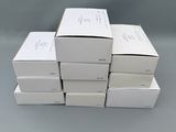 six white boxes stacked on top of each other on a table