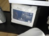 un sac contenant des oreillers et une taie d'oreiller posés sur une étagère