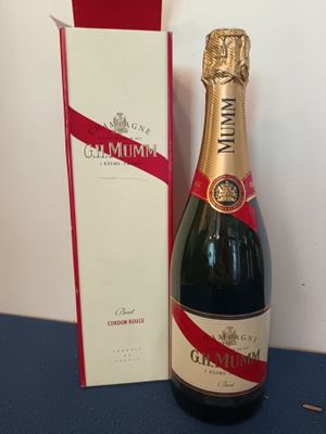 bottles of champagne and a box on a blue table