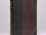 a black and brown leather book with a gold trim