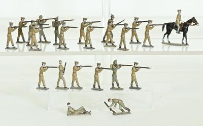many figurines of soldiers on display on a white surface