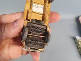 a person holding a small toy truck in their hand