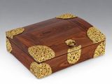 an ornate wooden box with gold decorations on it
