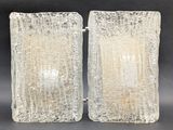 a pair of frosted glass bookends on a black background