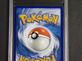 a close up of a pokemon card on a black surface