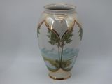 a white vase with a painting of a tree on it