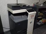 a black and white printer sitting on top of a desk