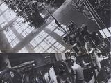 black and white photograph of a factory with workers working on machines