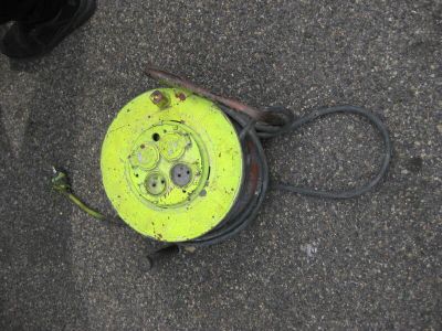 a yellow frisbee laying on the ground next to a pair of black shoes