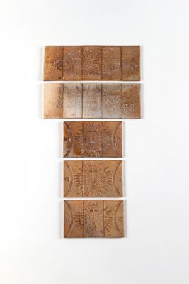 three pieces of wood are stacked on top of each other on a white wall