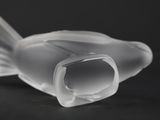 a plastic object that looks like a fish on a table