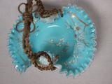 a small blue bowl with a bird on it