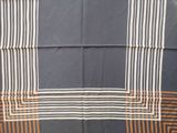 a close up of a blue and brown scarf with stripes
