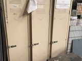 three lockers in a room with a lot of junk