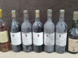 several bottles of wine are lined up in a row on a table
