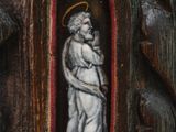 painting of a man holding a child in a carved wood frame