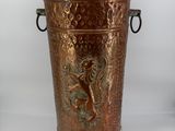 brass vase with a lion on the side of it on a white background