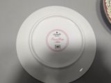 a white plate with a red and white design on it