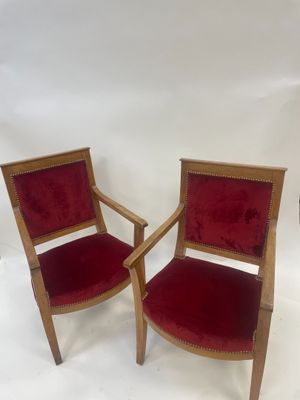 pair of red velvet upholstered armchairs