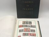 an open book with stamps on it sitting on a table