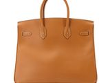 a brown leather handbag on a white background