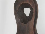 a wooden clock with a hole in the middle of it