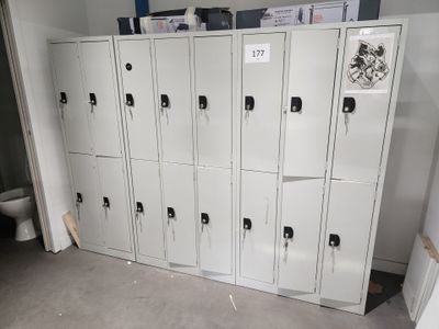 a bunch of lockers in a room with a toilet in the background