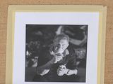 a black and white photo of a man holding a camera