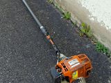 an image of a lawn mower laying on the ground
