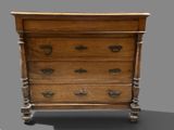 a small wooden chest of drawers on a gray surface