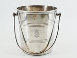 an antique silver plated ice bucket with handles on a white background