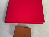 a red box with a brown box and a brown box on a white surface