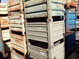 many crates stacked on top of each other in the dirt