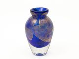 a blue glass vase with a gold leaf design on it