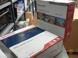many boxes of electronics sitting on a table in a room