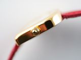 a close up view of a watch with a red strap