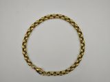 a gold bracelet on a white background