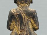 an image of a statue of a person sitting on top of a table