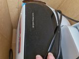 a hand that is holding a remote control in a box