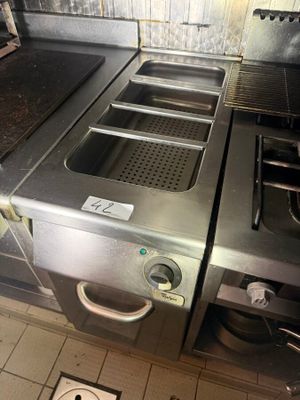 a picture of a commercial kitchen with stainless steel appliances