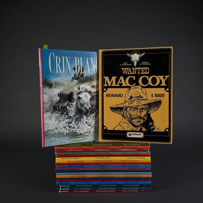two books are stacked on top of each other on a black background