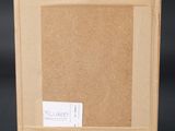 an empty picture frame on a black background with a sticker