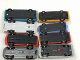 several toy cars are lined up in a row on a white surface