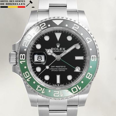 une montre Rolex avec un cadran noir et une lunette verte