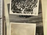 an old photo of a group of people and a plane in a case