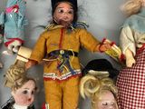 many dolls that are arranged in a circle on the floor
