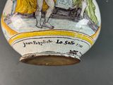 a vase with a picture of a man and a woman on it